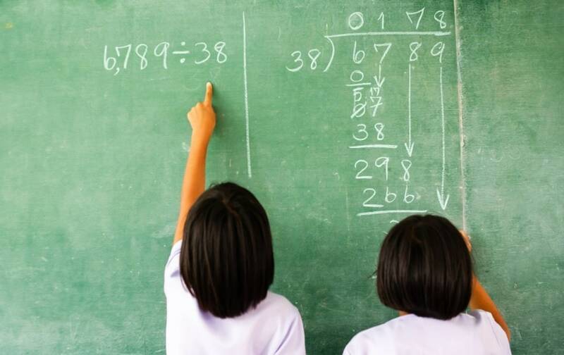 children doing long division on a chalkboard